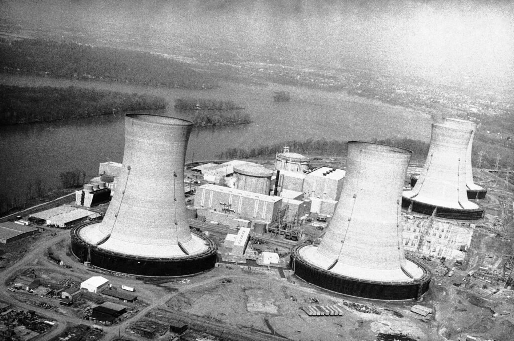 Aerial historical view of Three Mile Island nuclear power plant cooling towers and containment facility