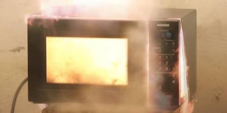 Operating microwave oven emitting heat and radio signal interference in a home kitchen setting.